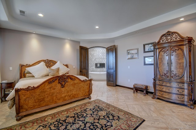 bedroom featuring a tray ceiling, recessed lighting, visible vents, stone finish flooring, and baseboards