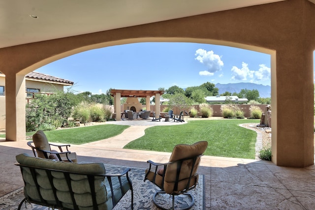 view of patio featuring fence and a mountain view