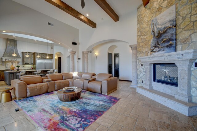 kitchen with pendant lighting, premium range hood, a high ceiling, built in appliances, and a kitchen island