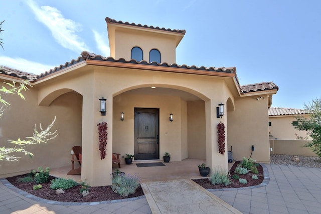 entrance to property featuring a patio area