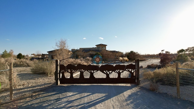 view of gate featuring a rural view and fence