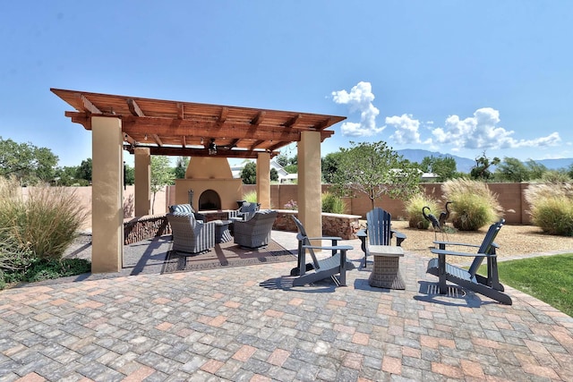 view of patio with a pergola and exterior fireplace