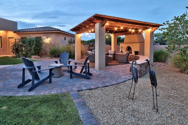 view of patio / terrace with an outdoor living space with a fireplace