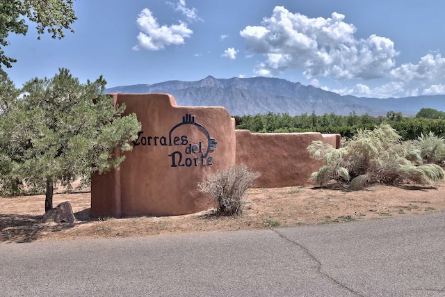 community / neighborhood sign with a mountain view