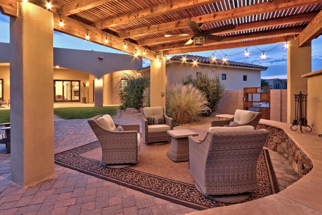 rear view of property featuring a patio area, a yard, and an outdoor fire pit