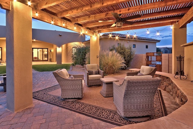 patio terrace at dusk featuring a ceiling fan, fence, and a pergola