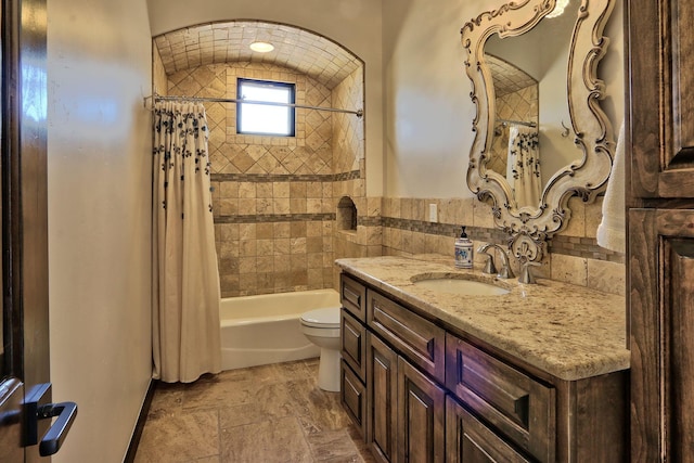 full bathroom with shower / tub combo, vanity, and toilet