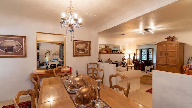 dining space with a notable chandelier and a textured ceiling