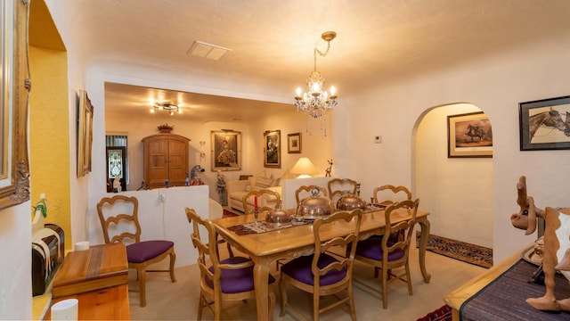 dining space featuring light colored carpet and a notable chandelier