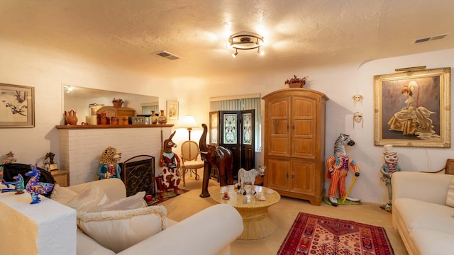 living room featuring a fireplace and a textured ceiling