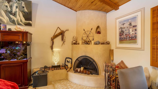 living room with wooden ceiling, beam ceiling, and a fireplace