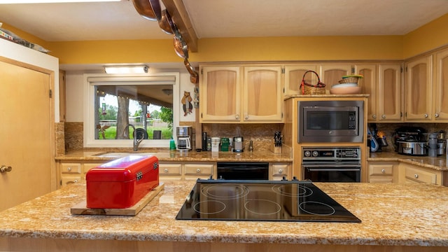 kitchen featuring sink, decorative backsplash, light brown cabinetry, and black appliances