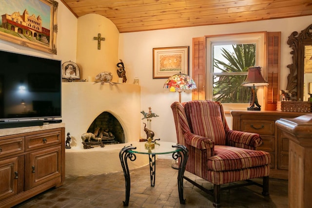 living area with vaulted ceiling and wooden ceiling