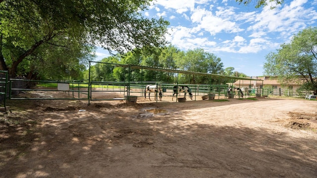 surrounding community featuring an outdoor structure and a rural view