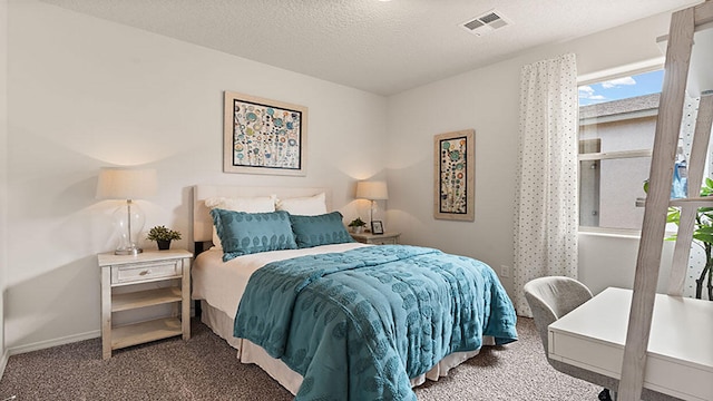 bedroom featuring dark carpet and a textured ceiling