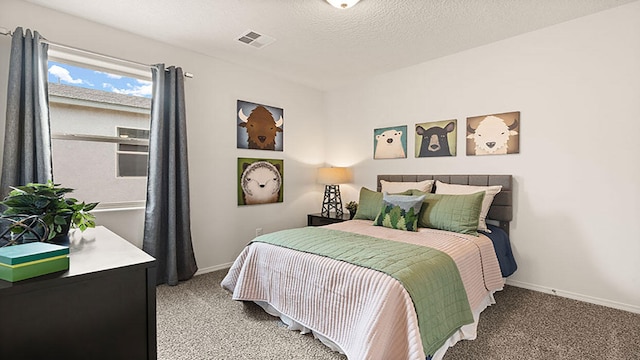 carpeted bedroom with a textured ceiling