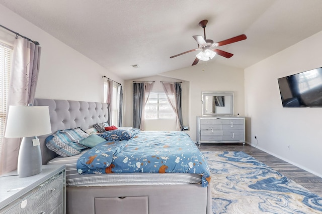 bedroom with hardwood / wood-style flooring, ceiling fan, and lofted ceiling