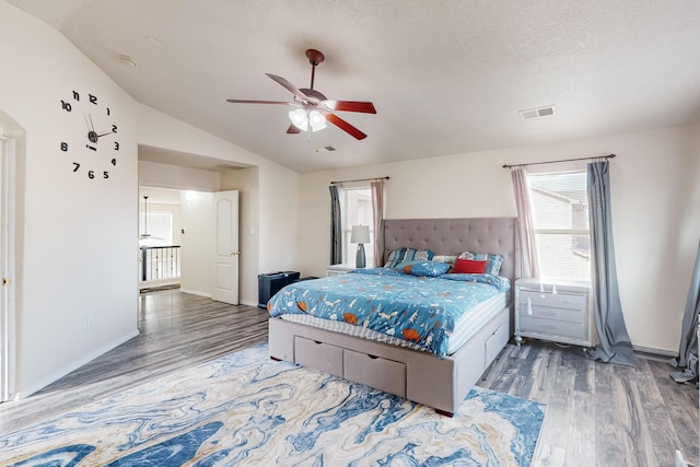 bedroom featuring hardwood / wood-style floors, a textured ceiling, ceiling fan, and lofted ceiling