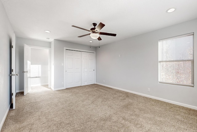 unfurnished bedroom featuring ceiling fan, carpet floors, and a closet