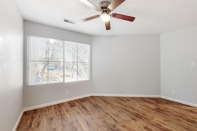 spare room with hardwood / wood-style flooring and ceiling fan