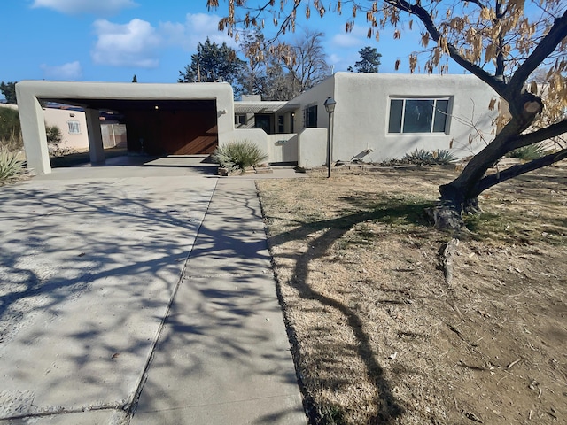 adobe home featuring a carport