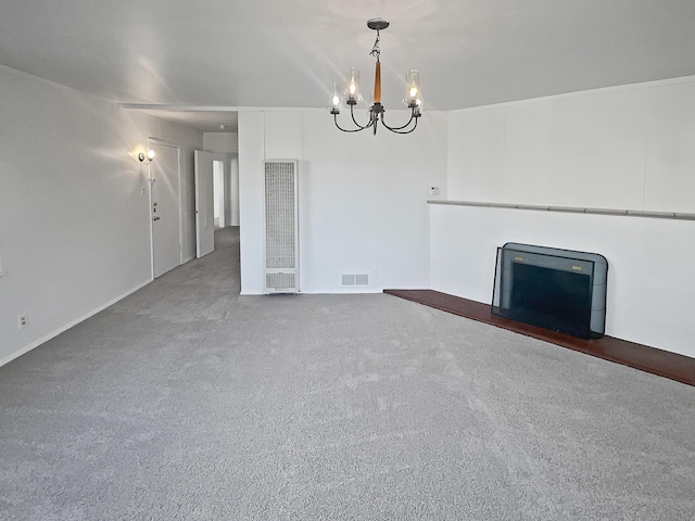 unfurnished living room with a chandelier and carpet floors