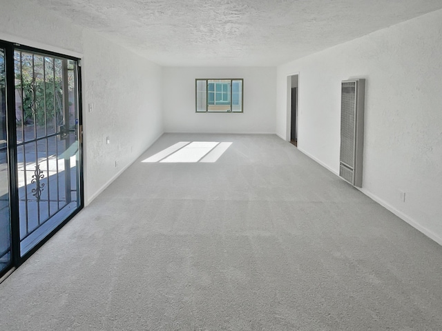 empty room featuring a textured ceiling and carpet floors