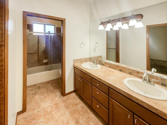 full bathroom with decorative backsplash, toilet, vanity, and combined bath / shower with glass door