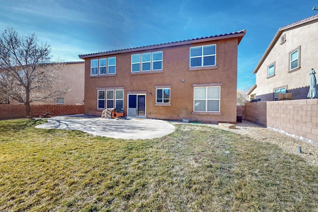 rear view of house with a patio area and a lawn