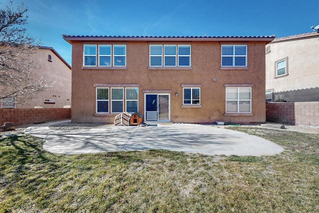 rear view of house with a lawn and a patio area