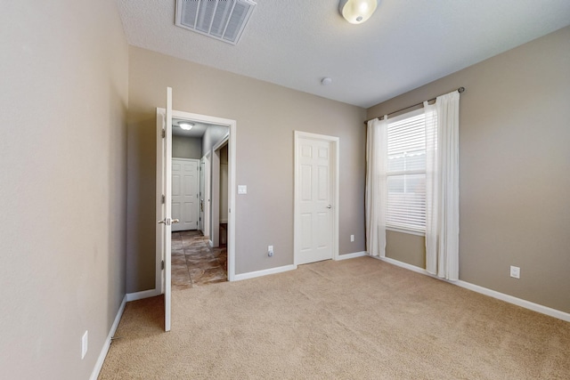 unfurnished bedroom featuring light colored carpet