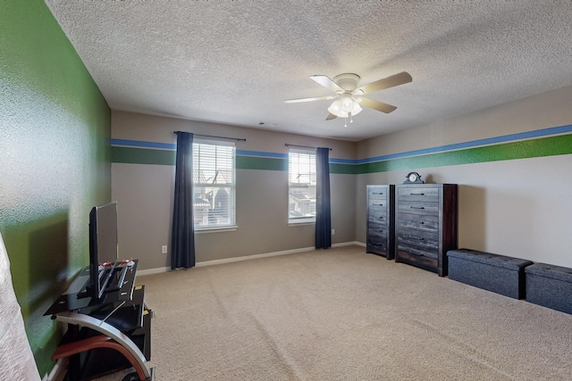 bedroom with a textured ceiling, carpet floors, and ceiling fan