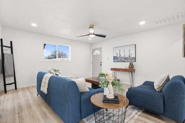 living room with light hardwood / wood-style flooring and ceiling fan