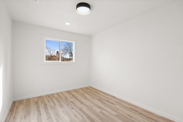 empty room with light hardwood / wood-style flooring