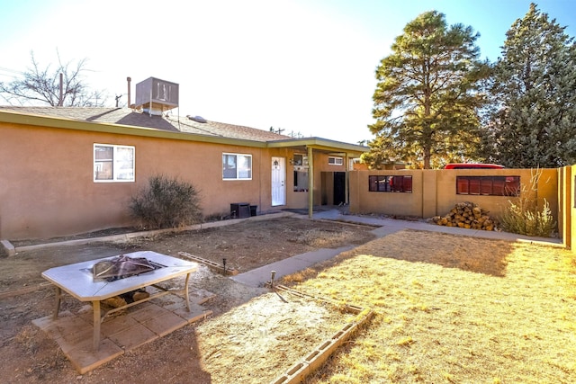 back of property featuring a fire pit