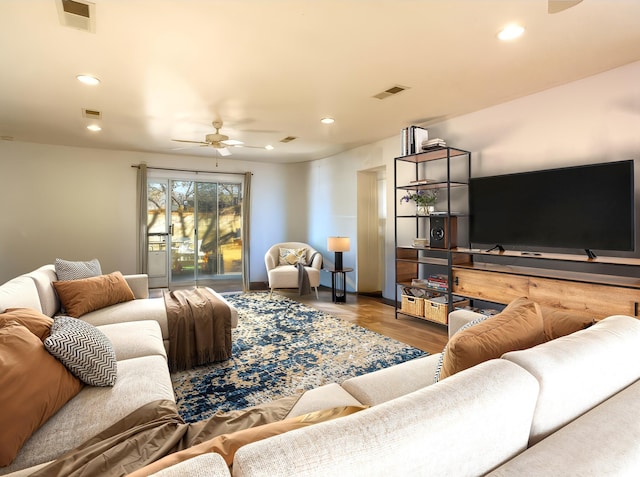 living room featuring recessed lighting, visible vents, and wood finished floors