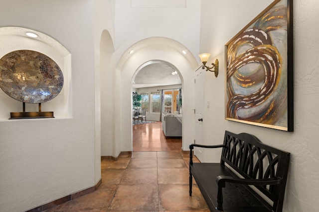 hall with arched walkways and a textured wall