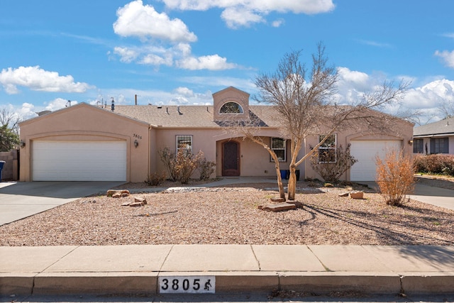 ranch-style house featuring a garage, driveway, and stucco siding