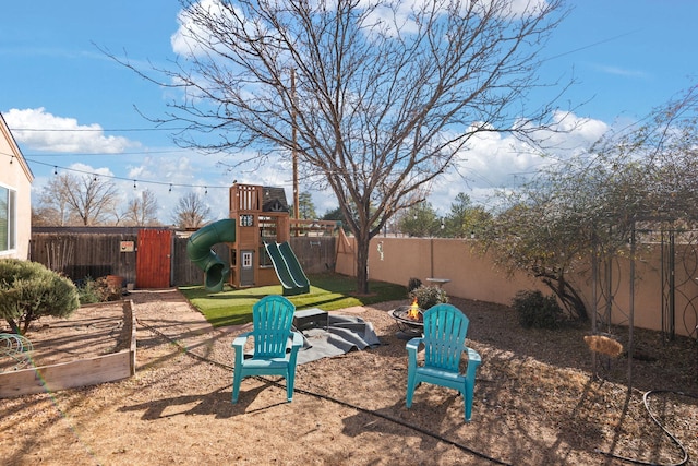 view of play area featuring a fenced backyard and a garden