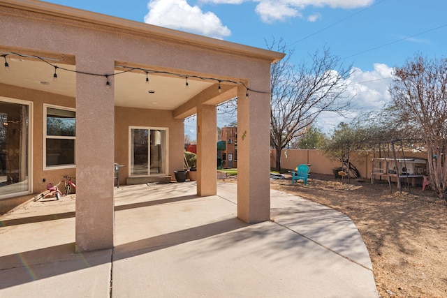 view of patio / terrace featuring fence