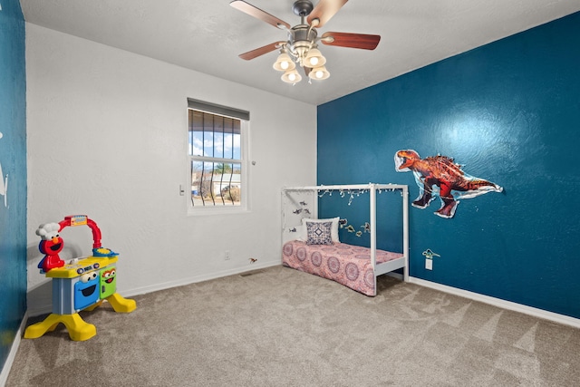 bedroom with carpet, ceiling fan, and baseboards