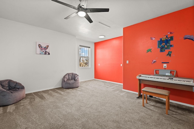 living area featuring ceiling fan, carpet floors, and baseboards