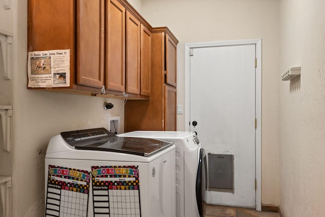 laundry area with independent washer and dryer and cabinet space