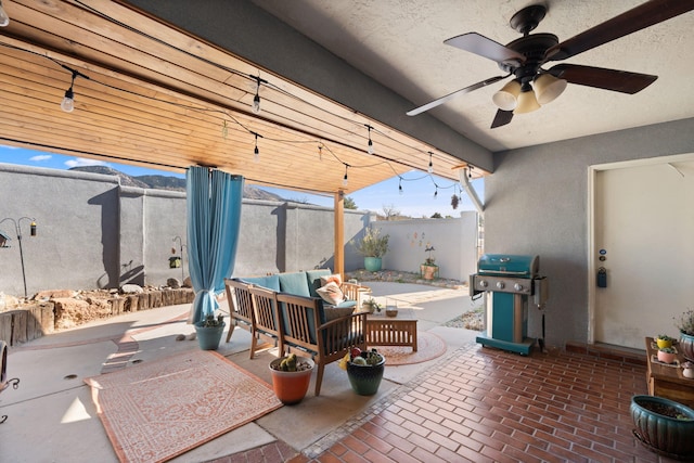 view of patio with ceiling fan, a grill, and an outdoor hangout area