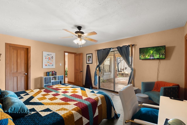 bedroom with access to exterior, wood-type flooring, a textured ceiling, and ceiling fan