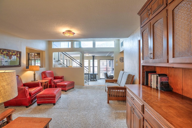 carpeted living room with a textured ceiling