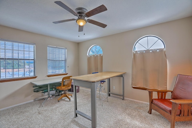 office space with ceiling fan and light colored carpet