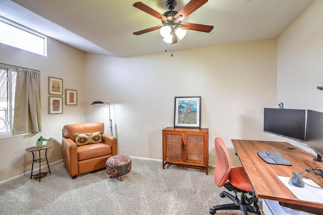 carpeted office space with ceiling fan