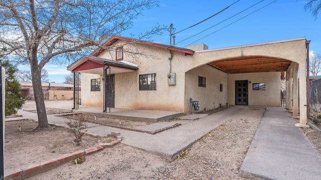 back of property featuring a carport