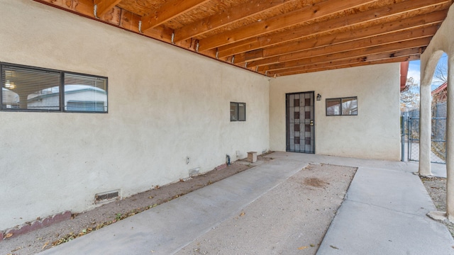 doorway to property featuring electric panel, a patio area, and french doors